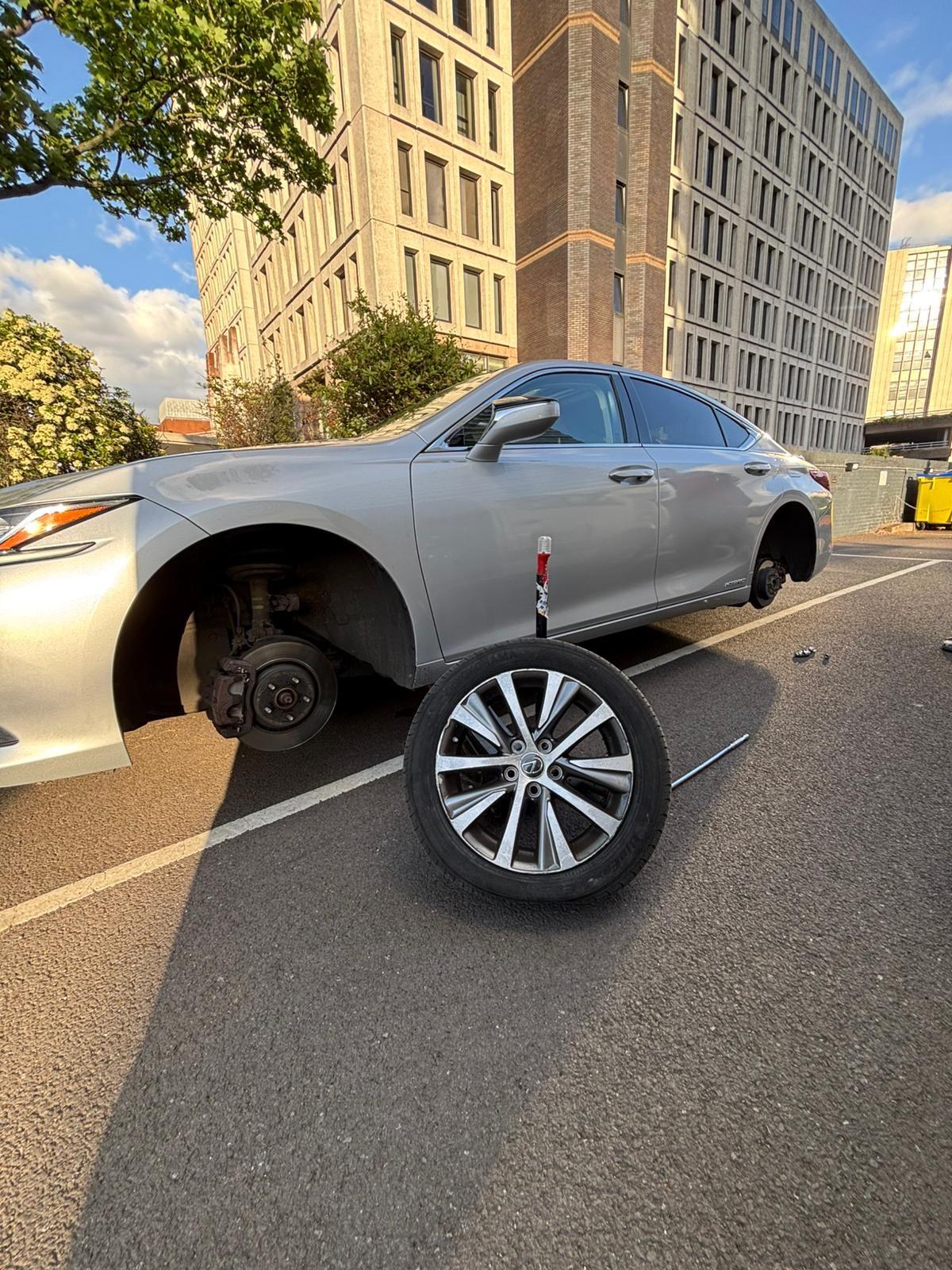 Lexus with wheel removed for mobile tyre fitting in Birmingham city centre
