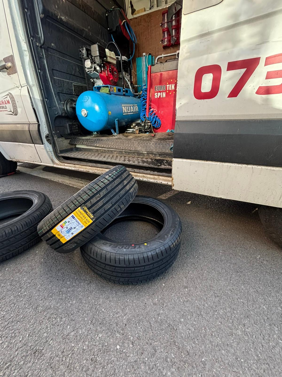 New tyres next to Birmingham Tyres World mobile van with equipment