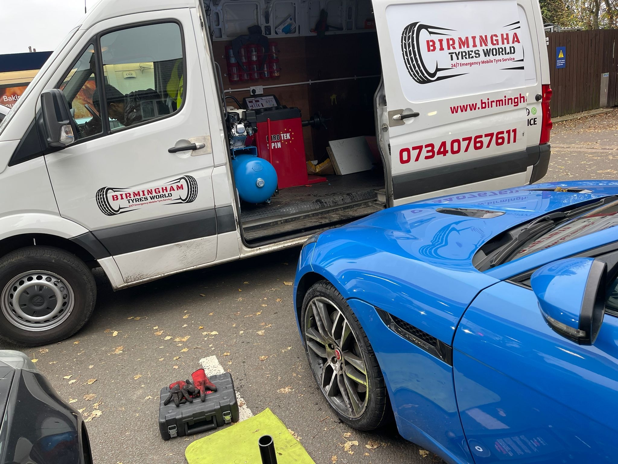 Birmingham Tyres World branded van with sports car during mobile tyre fitting